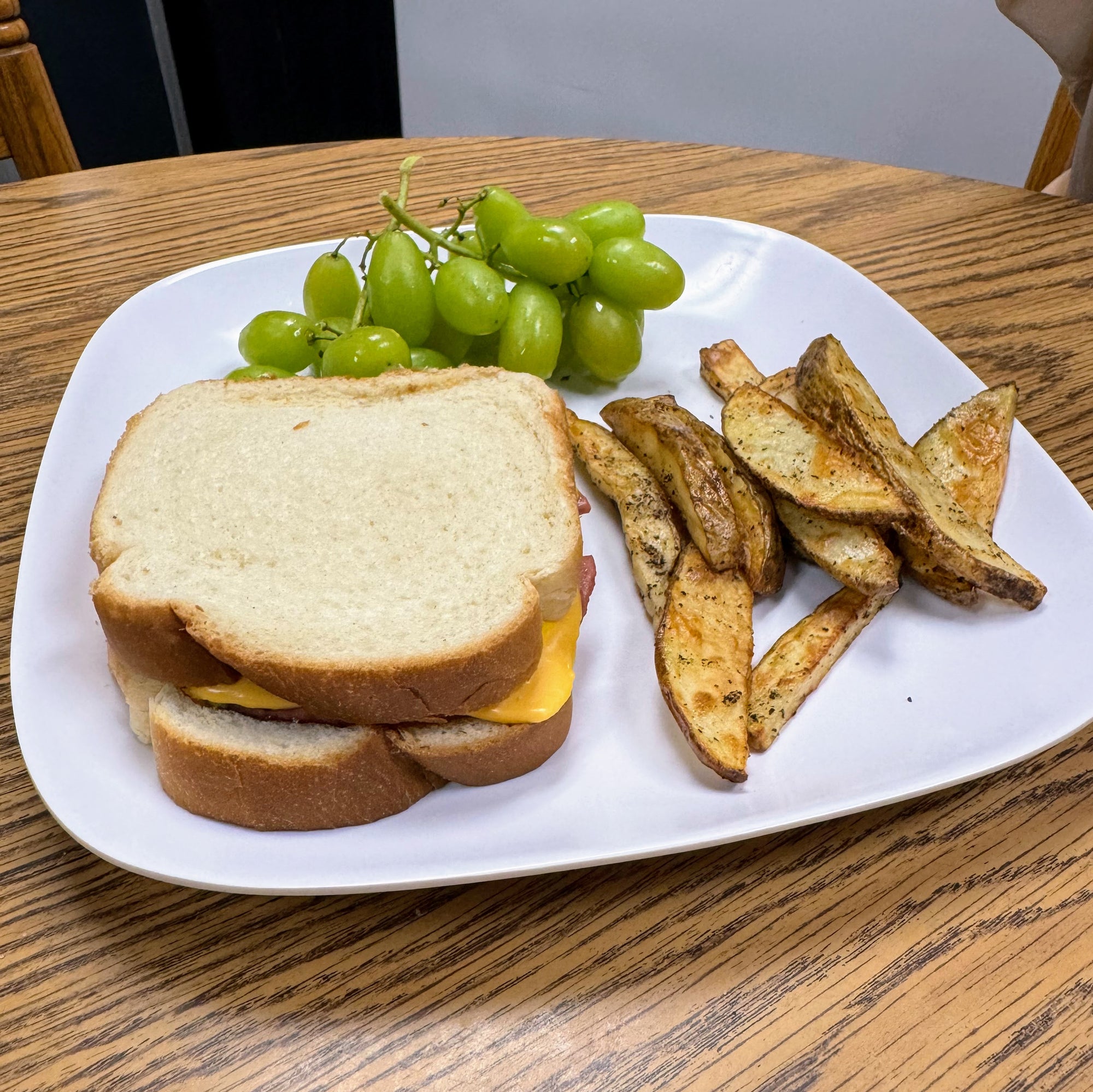 Bright Leaf Bologna Sandwich with Homemade Fries and Grapes
